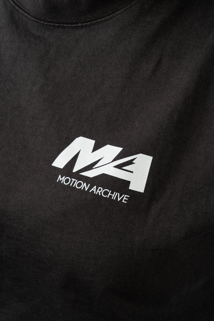 Close-up of a black t-shirt featuring a white printed 'MA' logo and 'MOTION ARCHIVE' text on the chest.